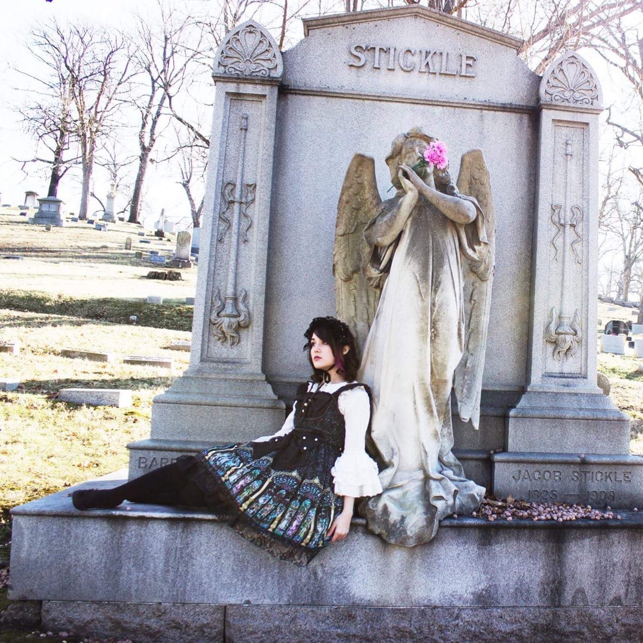 Me wearing a stained glass print dress, stretched on a gravestone