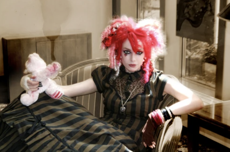 Emilie Autumn in a Victorian-inspired dress holding a teddy bear